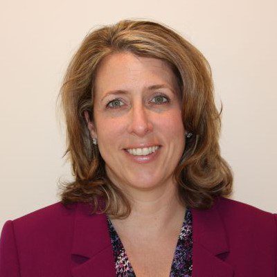 Photo of Christina Lattuca, CFO and VP of Operations wearing a blazer with white background